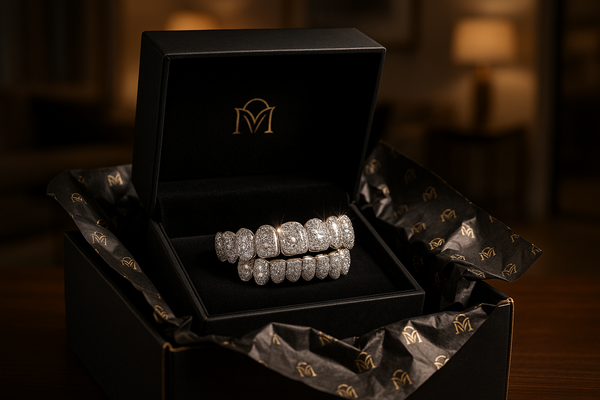 Luxury product delivery scene — custom grillz presented in a premium black velvet jewelry box with gold logo, placed inside a high-end black-and-gold shipping package with branded tissue paper, soft spotlight highlighting the sparkle of diamonds, blurred upscale home background, ultra-detailed hyper-realistic style, 8K photography.